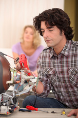 Man repairing television set