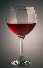 Glass of red wine on grey background