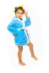 beautiful little girl with a comb in hair curlers