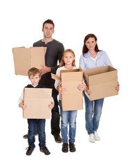 Fototapeta na wymiar Happy young family carrying boxes