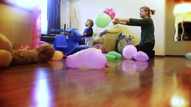Mother and baby boy playing with balloons