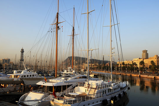 Luxury yachts moored in the harbor at sunset