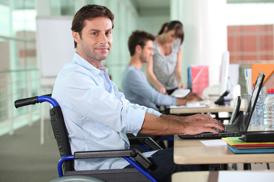 employee in wheelchair with laptop