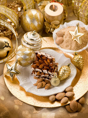 Obraz na płótnie Canvas almond nougat brittle over christmas table