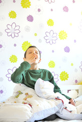 boy awakeing  in his bed