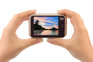 Hand with camera and beach landscape (my photo)