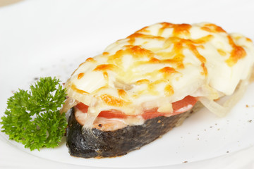 Salmon baked under vegetables and mayonnaise