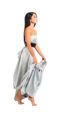 Naklejka premium beautiful woman wearing long silver dress goes on tiptoe