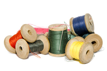 colored thread with a needle on a white background