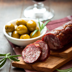 Cured dry sausage with green olives and rosemary