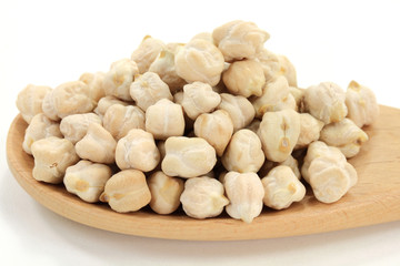 Chick Peas on pile, in wooden cooking spoon.
