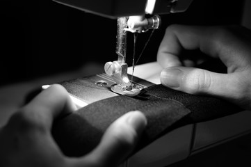 Hands of Seamstress Using Sewing Machine - obrazy, fototapety, plakaty