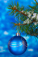 Christmas ball on the tree on blue