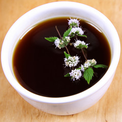 White Bowl of tea with mint twigs
