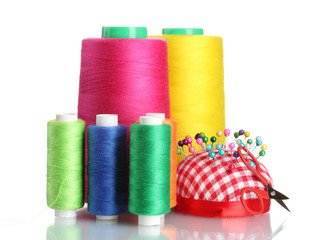 Bobbins of thread with colored pinheads in pin-cushion isolated