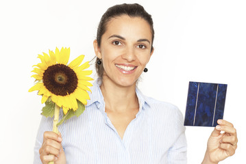Pretty woman with a solar cell and sunflower