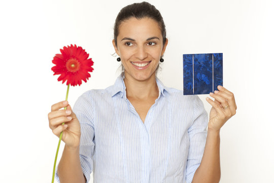 Pretty woman with a solar cell and flower