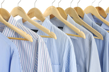 Assorted blue dress hanging on wooden hangers