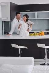 young couple have fun in modern kitchen