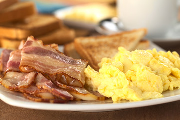 Fried bacon and scrambled eggs with toast bread