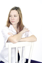 Beautiful tender woman sitting on a chair