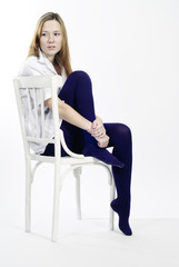 Fototapeta na wymiar Young woman sitting on a chair