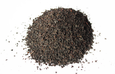The pile of the dry tea leaves on white background