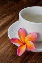 Obraz na płótnie Canvas Tropical Plumeria with Green Chinese Tea for spa and wellness co