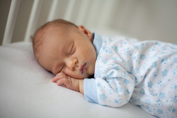 newborn sleeping in a crib