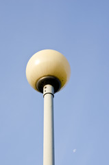 Glass ball on metal pole. Park lighting.