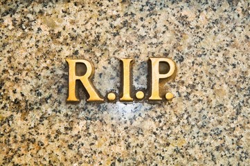 golden letters rip on granite tomb