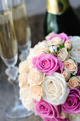 bridal bouquet of white and pink roses with wedding rings