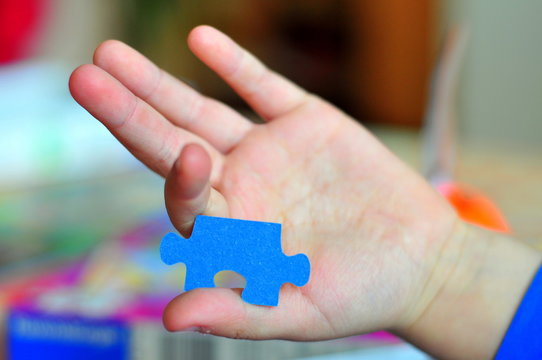 a hand holding piece of puzzle