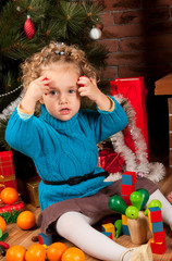 Fototapeta na wymiar Little girl playing near near Christmas tree