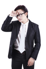 Tired Asian businessman isolated on white