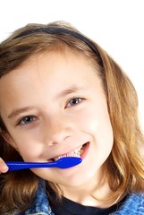 Girl brushing teeth on white background