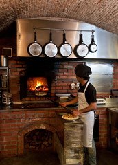 Pizza Chef put the pizza inside the Wood Oven