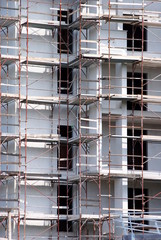 building under construction with rusted scaffold