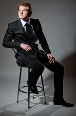 Smart looking male sat on bar stool