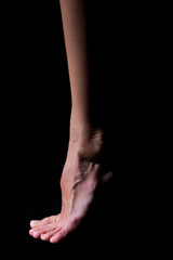 Fototapeta premium Bare foot on a black background