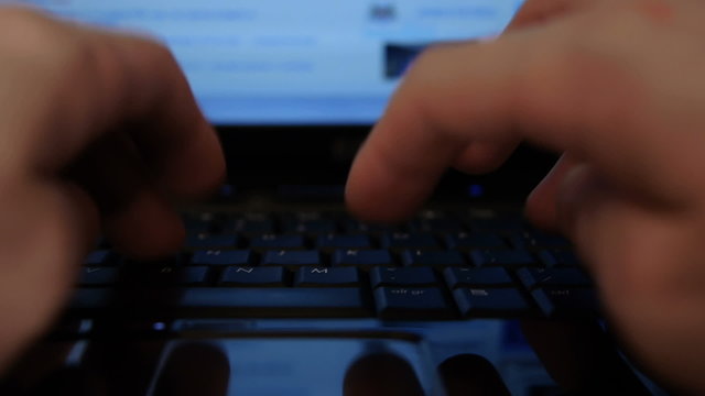 HD - Man's hands typing on notebook keyboard