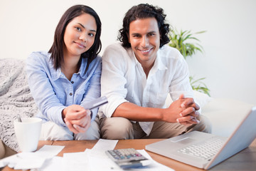 Couple doing online banking in the living room