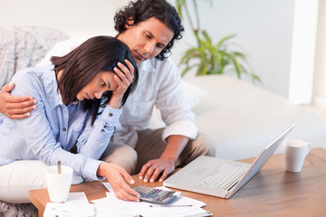 Side view of couple having a hard time paying their bills