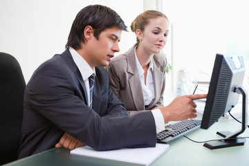 Good looking business people working with a computer