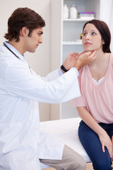 Male doctor examining his patients jaw