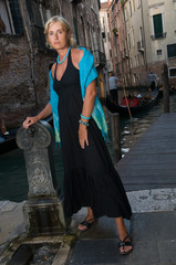 Venice, Italy - woman in black dress on the bridge in Venice