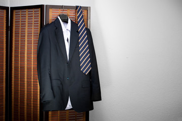 Mens suit hanging on hangers