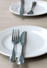 Empty plate, spoon and table-knife