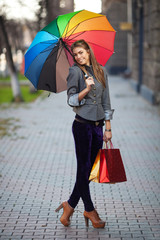 A shopping woman carrying shopping bags outdoor