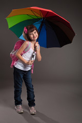 Portrait of a cute small girl going to school. Studio shot